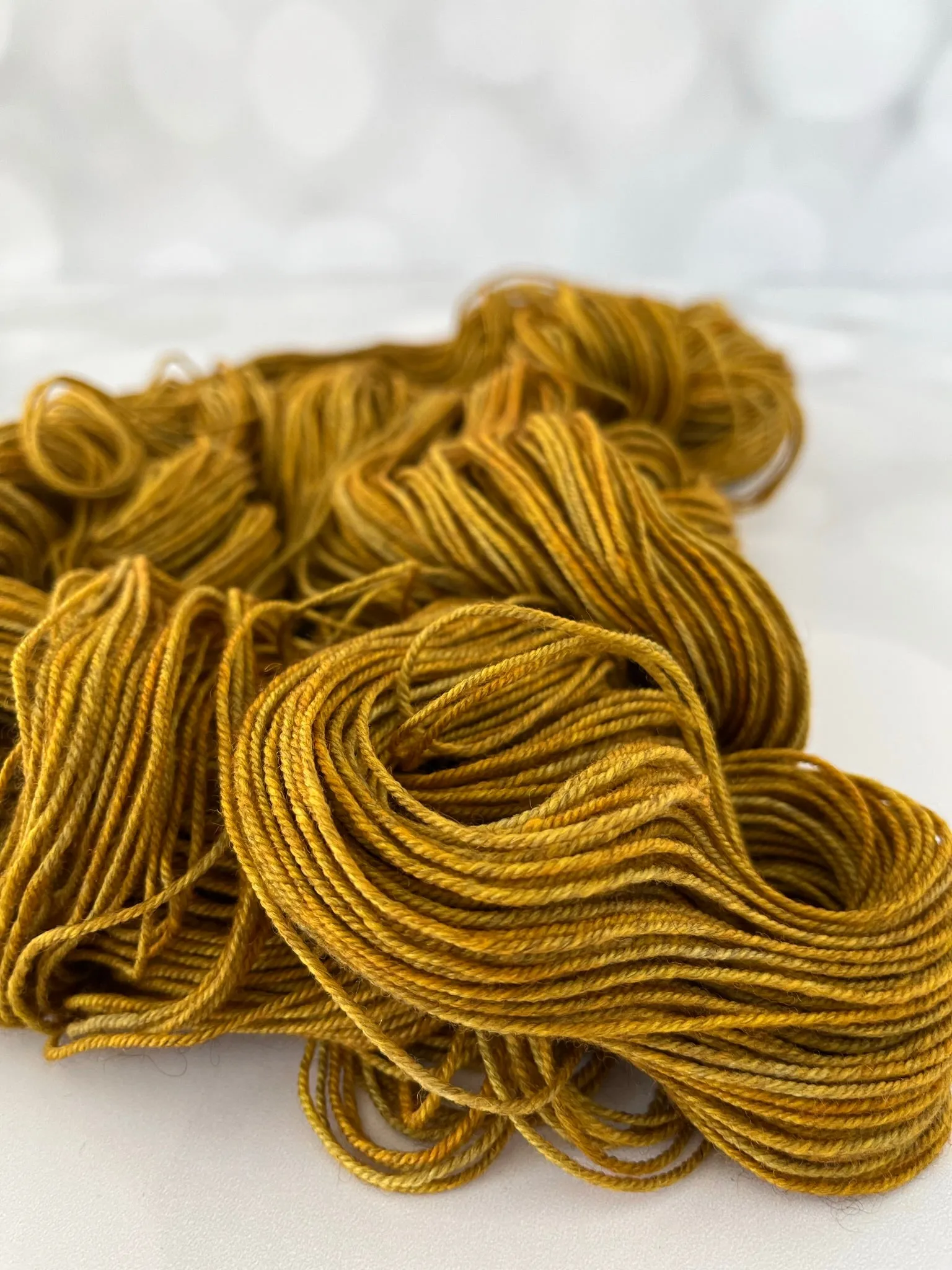 Tarnished Brass, Treasured Yak Toes Sock Yarn, goldenrod yellow yarn